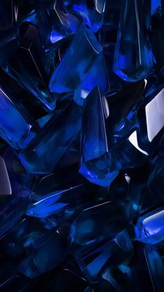 many blue crystals are scattered together in the dark night sky, as if they were crystal shards