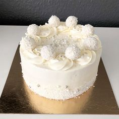 a cake with white frosting and decorations on top