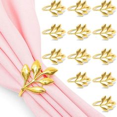 gold leaf napkin rings on top of pink cloth