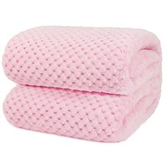 two pink towels stacked on top of each other