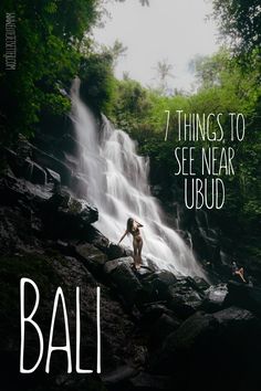 a woman standing in front of a waterfall with the text 7 things to see near ubud