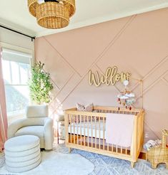 a baby's room decorated in pink and gold