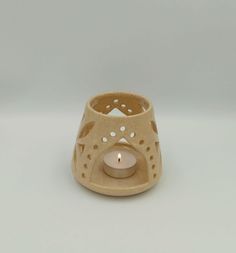 a small candle holder with a lit candle in it