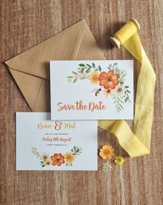 the wedding stationery is laid out on top of an envelope and some yellow ribbon