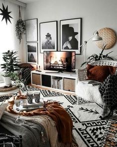 a living room filled with lots of furniture and pictures on the wall next to a window