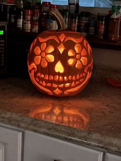 a carved pumpkin sitting on top of a kitchen counter