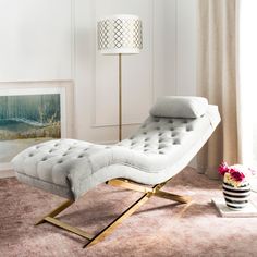 a white chaise lounge chair in a living room