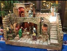 an outdoor nativity scene with figurines on display