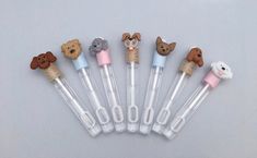 six pens with animals on them are lined up in the shape of pen holders,