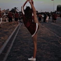 a woman is doing a handstand in the air