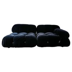 two black couches sitting next to each other