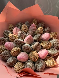 a bunch of chocolates in a pink paper wrapper