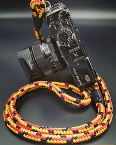 a camera with a colorful rope attached to it