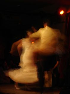 blurry photograph of two people dancing on stage