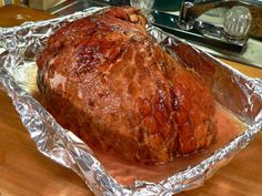 a large piece of meat sitting on top of tin foil