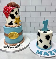 two decorated birthday cakes sitting on top of each other