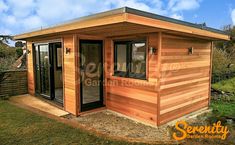 a small wooden shed with the door open and windows closed on it's side