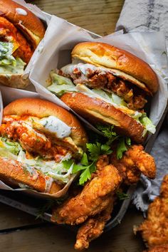 four sandwiches with different toppings sit on a tray