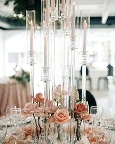 an elegant centerpiece with candles and flowers