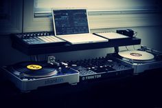 two turntables and a laptop on a table