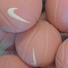 several pink nike basketballs stacked on top of each other