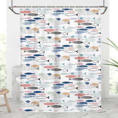 a shower curtain with colorful fish on it