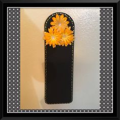 a black and white polka dot border with yellow flowers on it's back side