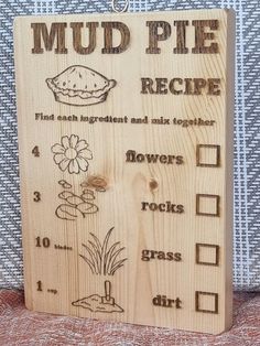 a wooden sign with instructions on how to make a mud pie recipe for the garden