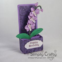 a birthday card with purple flowers in a box