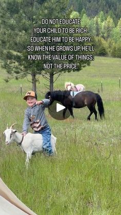 a young boy is petting a horse in a field