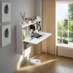 a white desk in front of a window next to a wall mounted air purificater