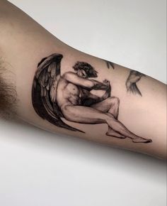 a man's arm with an angel tattoo on it