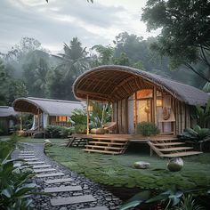 a bamboo house with steps leading up to it and trees in the background at dusk