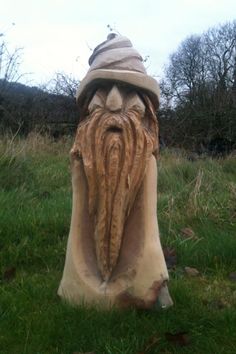 a statue of an old man with a beard and hat on it's head