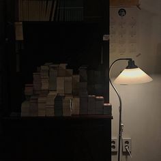 a lamp that is sitting next to a book shelf