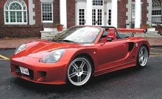 a red sports car parked in front of a building