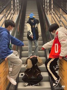 three young men riding down an escalator with their hands on each other's hips