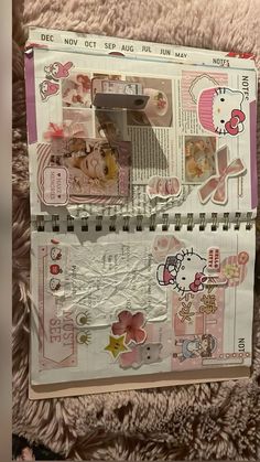 an open hello kitty scrapbook with stickers on it