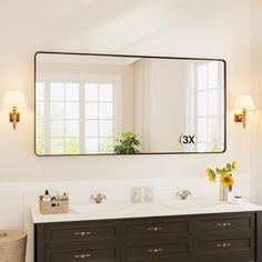 a bathroom vanity with two sinks and a large mirror above it, in front of a window