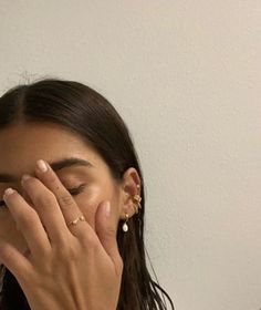 a woman covering her face with both hands