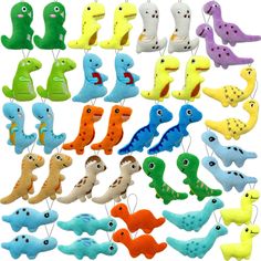 a bunch of different colored toy animals hanging from clothes pins on a white background with clippings in the shape of letters