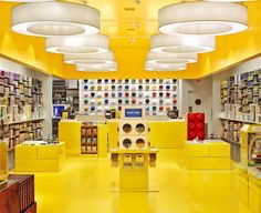 the inside of a store with yellow flooring and shelves filled with various types of items