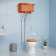 a white toilet sitting next to a sink in a blue tiled bathroom under a wooden shelf