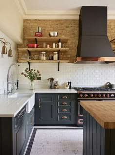 a kitchen with black cabinets and white counter tops