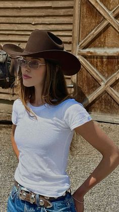 a woman wearing a cowboy hat and glasses