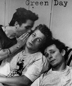 three young men laying in bed with the words green day written on their foreheads