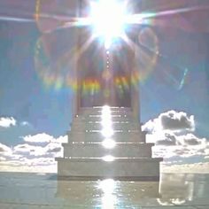 the sun shines brightly behind a monument