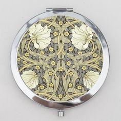 a compact mirror with an ornate design on it