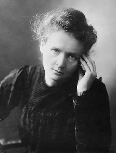 an old black and white photo of a woman with her hand on her head, looking at the camera