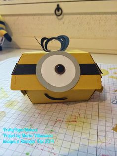 a yellow box with a black and white eyeball on it sitting on top of a table